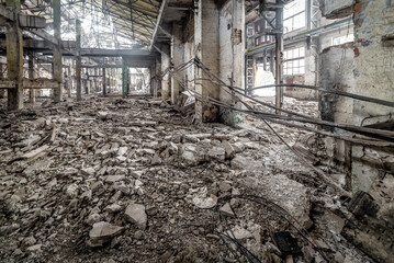 Industrial abandoned interior. Ruins of old factory. High voltage cables