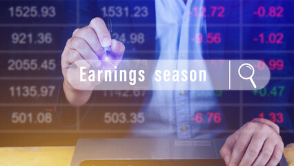 Earnings season Hand touching of written in search bar with the financial data visible in the background,  Reports Stock Market Ticker Words