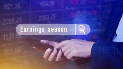 Earnings season, Hand touching of written in search bar with the financial data visible on background with smartphone,  Reports Stock Market Ticker Words