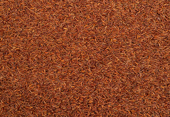 Red rice groats background. Rice texture.