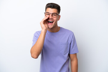Young caucasian man isolated on white background shouting with mouth wide open
