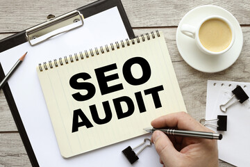 SEO AUDIT. Business concept. open notepad on a wooden table. coffee on a brown wooden table at the workplace in the office.