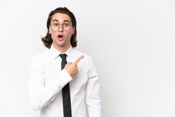 Business handsome man isolated on white background surprised and pointing side