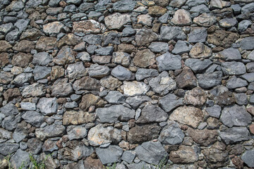 Architecture textures, detailed view of a traditional paired masonry, mixed granite and limestone wall, used on a fortress castle wall