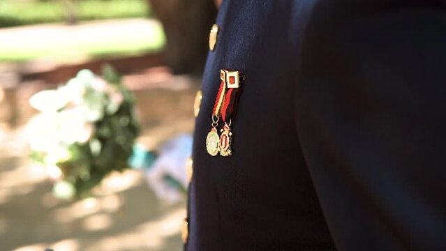 slow motion shot of a decorated soldier wearing his medals on his outfit