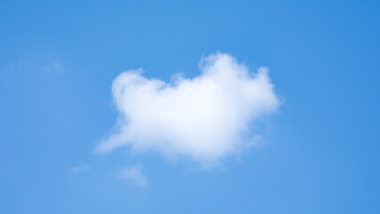 blue sky with heart shaped cloud background.