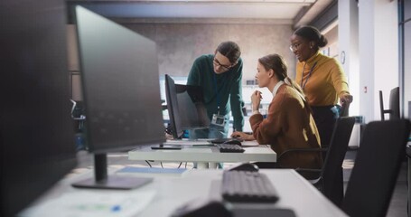 Diverse Multiethnic Group of Female and Male Students Sitting Together in Infographics Room, Collaborating on a College Project. Young Scholars Talking, Study Software Development or Computer Science