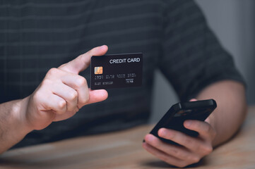 Businessman holding credit card and typing on laptop for online shopping and payment makes a purchase on the Internet, Online payment, Business financial and technology