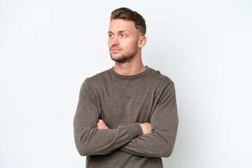 Young blonde caucasian man isolated on white background looking to the side