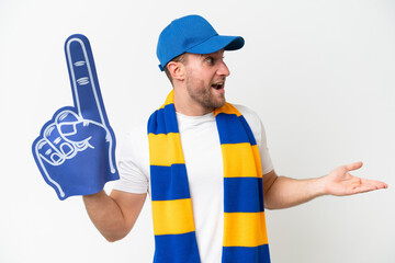 Young caucasian sports fan man isolated on white background with surprise expression while looking side