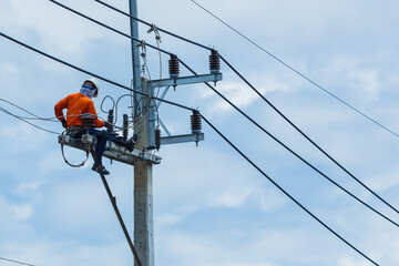 Electricians Wiring Cable repair services,worker in crane truck bucket fixes high voltage power...