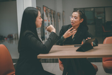 Businesswoman of senior management colleagues at meeting Professional businessmen work together on a SWOT analysis plan in a conference room via laptop.