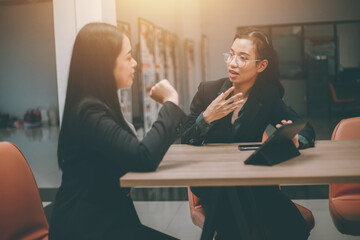 Businesswoman of senior management colleagues at meeting Professional businessmen work together on a SWOT analysis plan in a conference room via laptop.