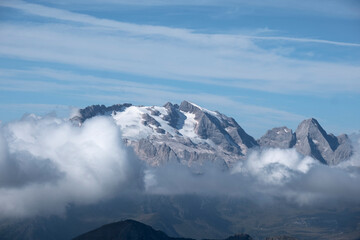 Fototapeta na wymiar Marmolada glacier and low clouds in the Italian Dolomites