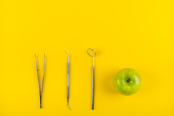 Dental metal equipment tools and green apple for healthy teeths