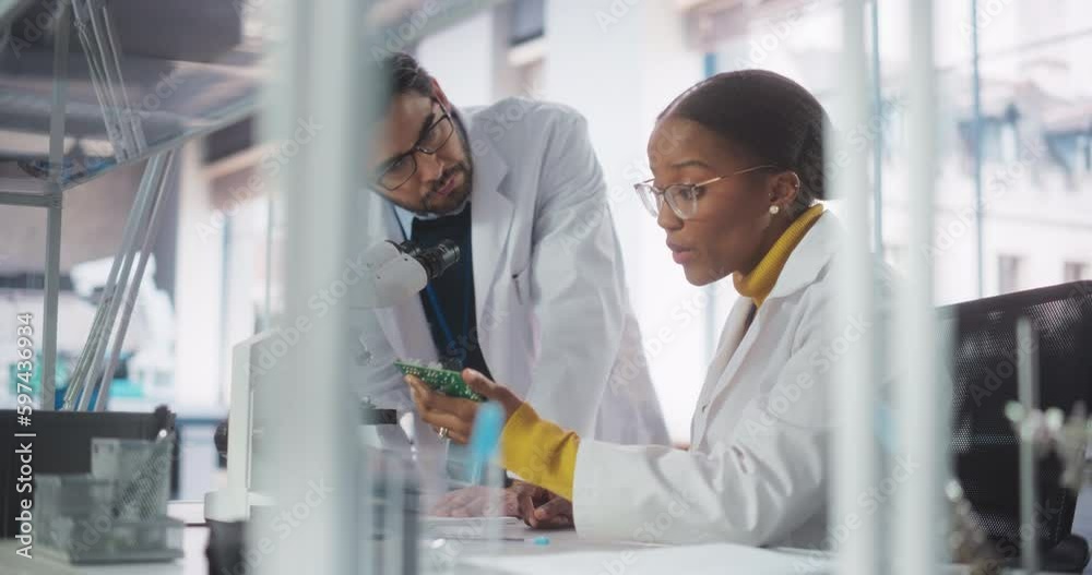 Poster African Girl Having a Conversation with a Team Leader in a Science Experiment Laboratory, While Working on an Advanced Circuit Board Project. Scientist Explaining the Assignment to a Young Intern
