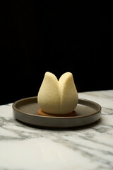 Tulip shape candy dessert on plate, close-up