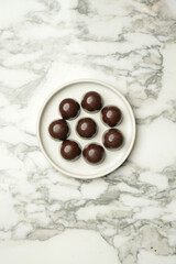 Chocolate Truffle candy on a white plate