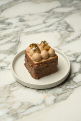 Chocolate souffle dessert with nuts on a white plate