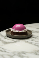 Pink cupcake dessert with coconut flakes and chocolate