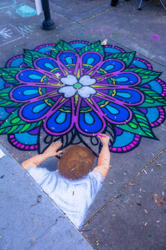 Knoxville, TN, USA 4-1-23: Dogwood chalk walk festival with many artists creating chalk art on the sidewalks.  Beautiful colors and room for copy space.  Street art.