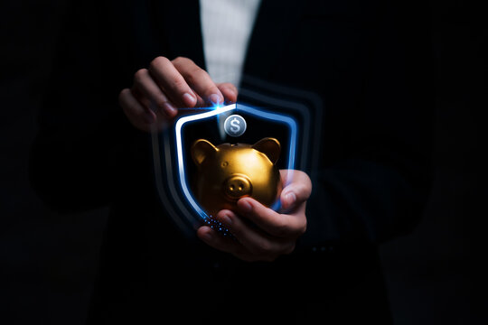 Business hand protecting and saving gold piggy bank, Stock funding or money saving. Saving for investment and retirement, Stack of the gold,  money and target of financial planning concept.