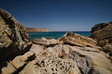 View of the rocky landscape of the Tris Klisies beach in Ios Greece