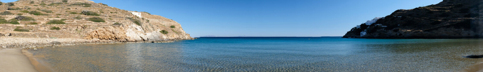 Fototapeta na wymiar Real panoramic view of the stunning turquoise sandy beach of Kolitsani in Ios Cyclades Greece