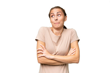 Young caucasian woman over isolated background making doubts gesture while lifting the shoulders