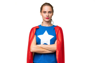 Young caucasian woman over isolated background in superhero costume with arms crossed © luismolinero