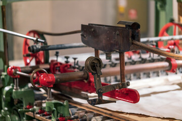 Mechanical paper machine closeup on details.