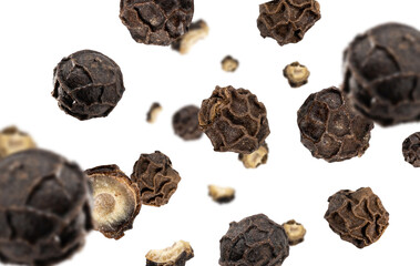Close-up organic peppercorn, whole and sliced, flying on white background. Floating dried black pepper. Spicy additive ingredient for delicious delicacies. Creative spices food concept. Macro photo