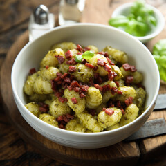 Homemade potato gnocchi with pesto and sausage 