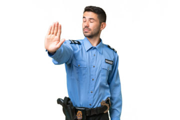 Young police caucasian man over isolated background making stop gesture and disappointed