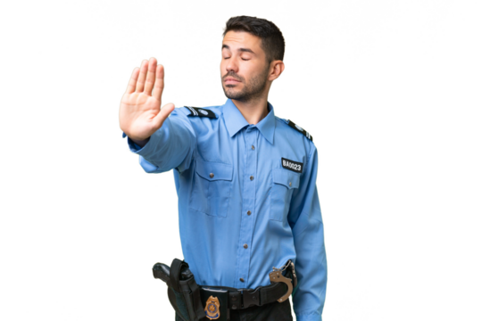 Young police caucasian man over isolated background making stop gesture and disappointed - Powered by Adobe