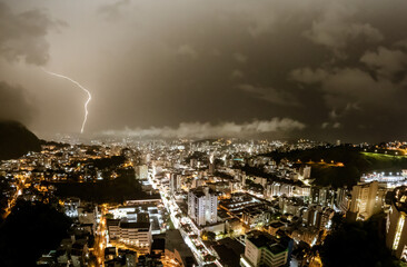 Thunderstorm over the illuminated cityscape