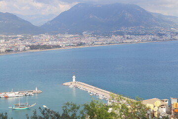 Landscape with marina on Alanya peninsula, Antalya region, Turkey, Asia. Famous tourist destination with high mountains. Part of the ancient old castle. Summer bright day.