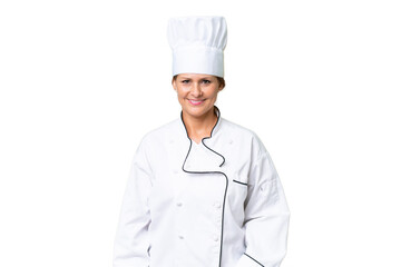 Middle-aged chef woman over isolated background laughing