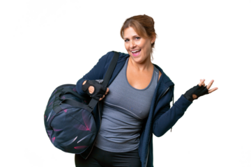 Middle-aged sport woman with sport bag over isolated background making guitar gesture