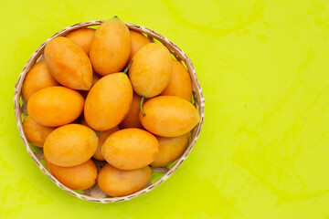Marian plum fruit isolated on green background