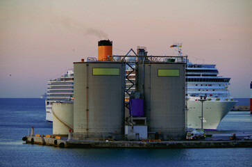 Modern white cruiseship or cruise ship liner Deliziosa in port of Mykonos, Greece during Mediterranean Greek Island cruising to Med for dream holiday vacation