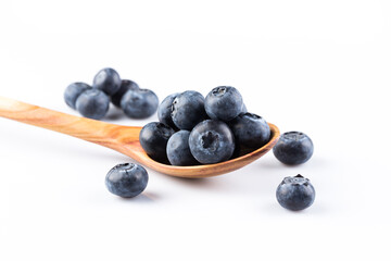 Fresh blueberries in wooden spoon