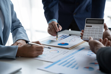 Group of business people brainstorming in analytical plan meeting Calculate the numbers obtained from the graph. Financial growth chart. Marketing. Concept of business success statistics.