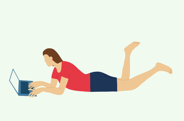 A young woman in casual clothes lies down using a laptop at home.