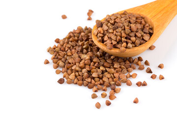 Uncooked buckwheat on wooden spoon