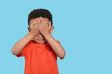 Emotional African-American boy on turquoise background. Space for text