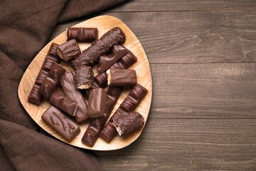 Tasty chocolate bars on wooden table, flat lay. Space for text