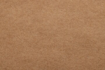 Fototapeta na wymiar Texture of brown paper sheet as background, top view