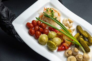 A plate of food with mushrooms and pickles on it