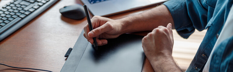 Close up of man designer in headphones works in home office. High quality photo